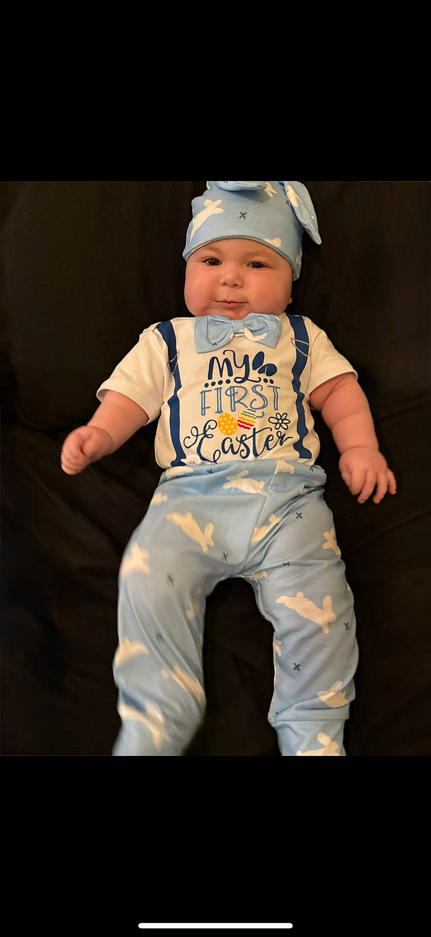 accessories, baby, bodypart, bonnet, cap, clothing, couch, face, finger, formalwear, furniture, hand, hat, head, newborn, pants, person, photography, portrait, tie