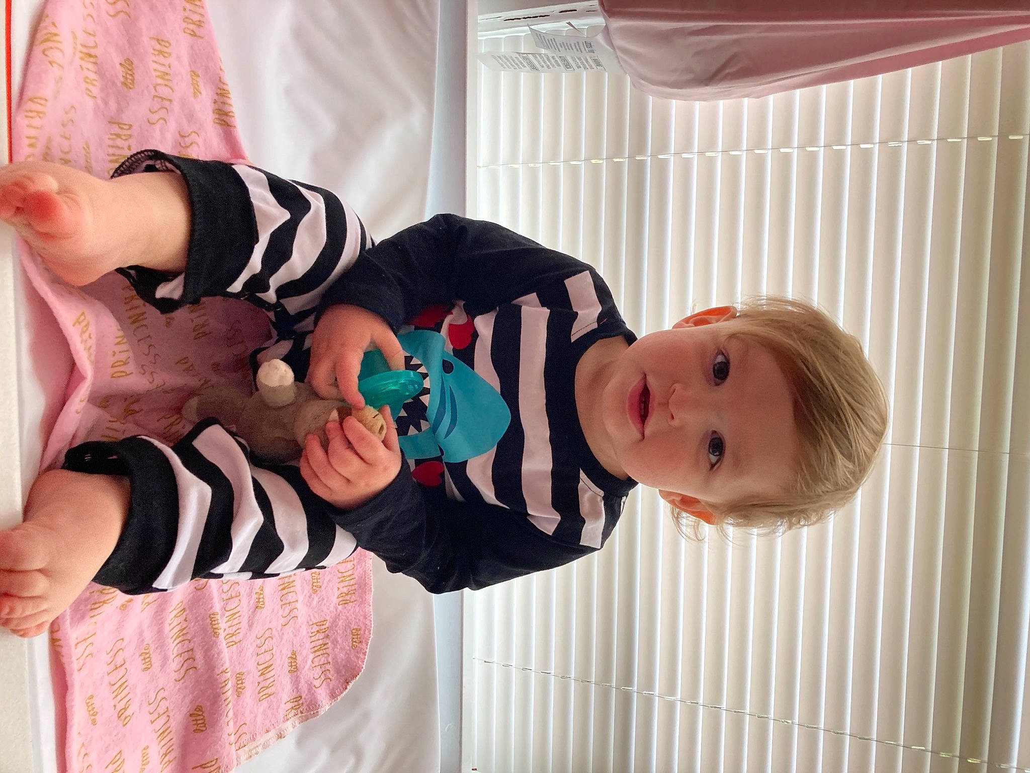 Calvin joined the competition — help win amazing prizes! baby, baby_products, baby_toddler_clothing, child, dress, facial_expression, finger, gesture, happy, human_body, pattern, person, pink, skin, sleeve, smile, sock, textile, toddler, vertebrate