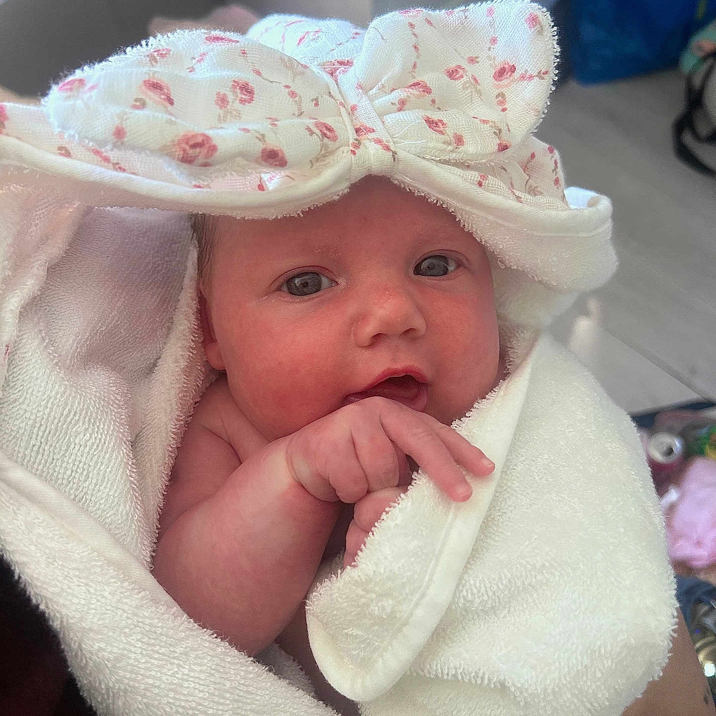 Gracie is registered to the contest to win money with this photo: adorable, baby, bow, child, closeup, cute, eyes, face, hand, headband, indoor, infant, newborn, person, pink, skin, soft, towel, white, wrapped