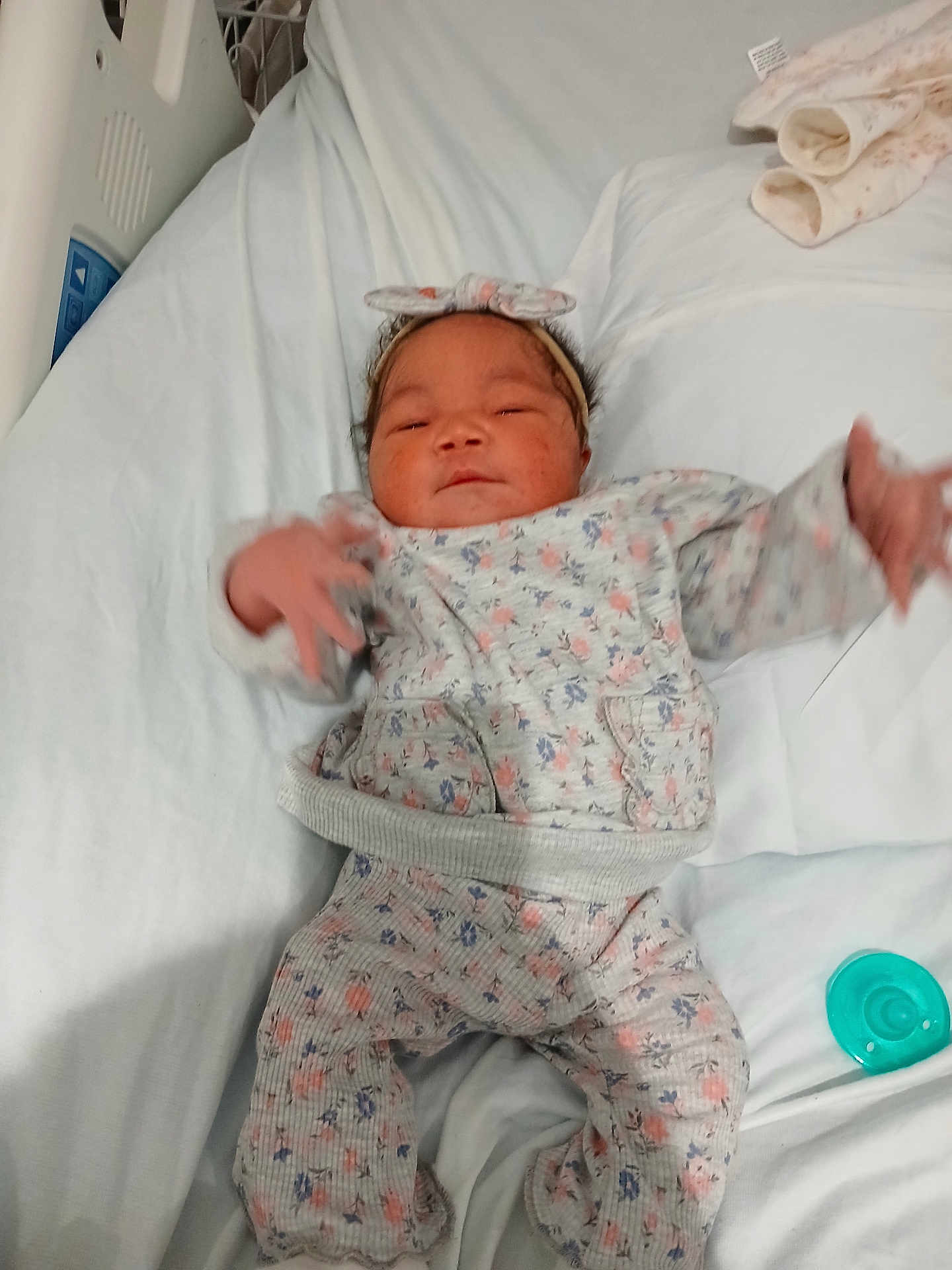 Pheonyx joined the competition — help win amazing prizes! baby, infant, bed, blanket, headband, floral_pattern, clothing, pacifier, hand, sleepwear, newborn, person, cute, indoors, soft, fabric, resting, child, hospital_bed, comfort