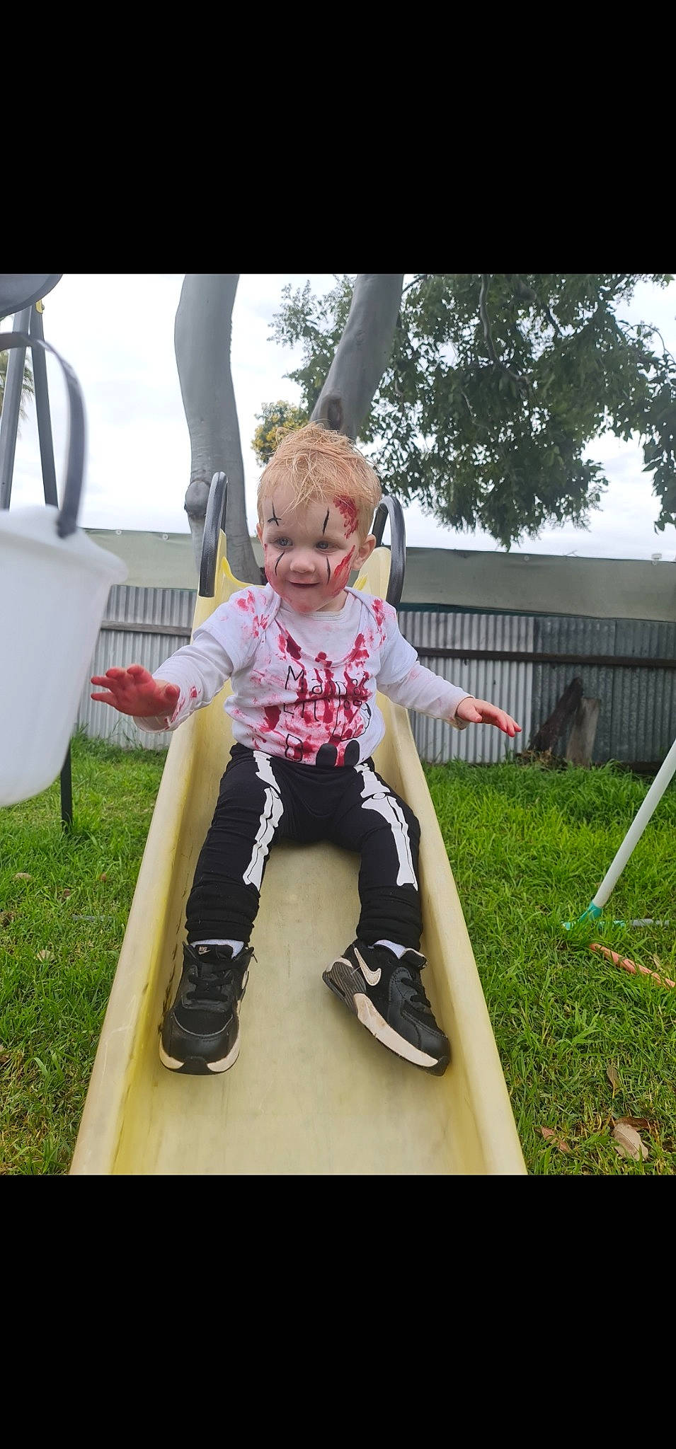 Toby is registered to the contest to win money with this photo: chair, child, fun, grass, happy, joy, knee, leisure, magenta, outdoor_play_equipment, person, recreation, sitting, sky, sleeve, sportswear, summer, t_shirt, thigh, toddler