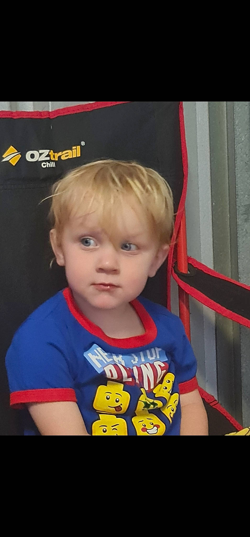 Toby is registered to the contest to win money with this photo: bangs, blond, cheek, child, chin, cool, electric_blue, eyelash, fun, hairstyle, happy, logo, nose, person, photo_caption, product, room, sleeve, snapshot, t_shirt