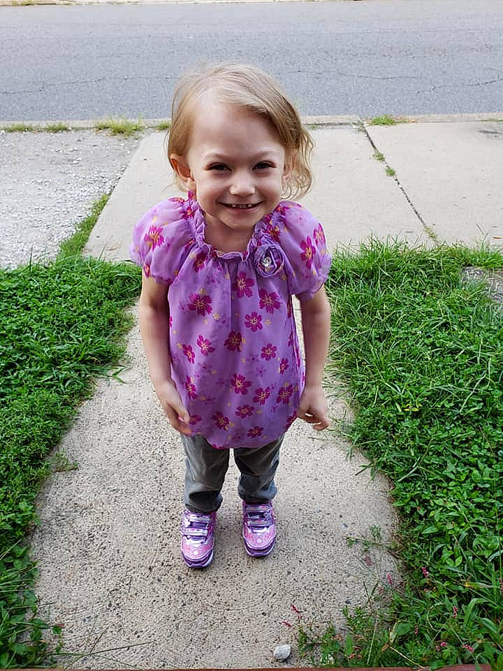 Jailynn is registered to the contest to win money with this photo: child, day, fun, girl, grass, happiness, infant, joy, outerwear, pattern, person, pink, plant, play, purple, sitting, skin, smile, standing, toddler