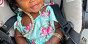 Heaven joined the competition — help win amazing prizes! accessory, baby, baby_toy, bracelet, car_seat, child, closeup, curly_hair, cute, dark_skin, floral_dress, happy, indoors, infant, pink_bow, playing, portrait, seat, seatbelt, smiling