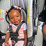 baby, car_seat, child, smiling, pink_clothing, hair_bows, seatbelt, infant, cute, happy, person, indoor, safety, car_interior, portrait, toddler, clothing, skin, seat, baby_accessory