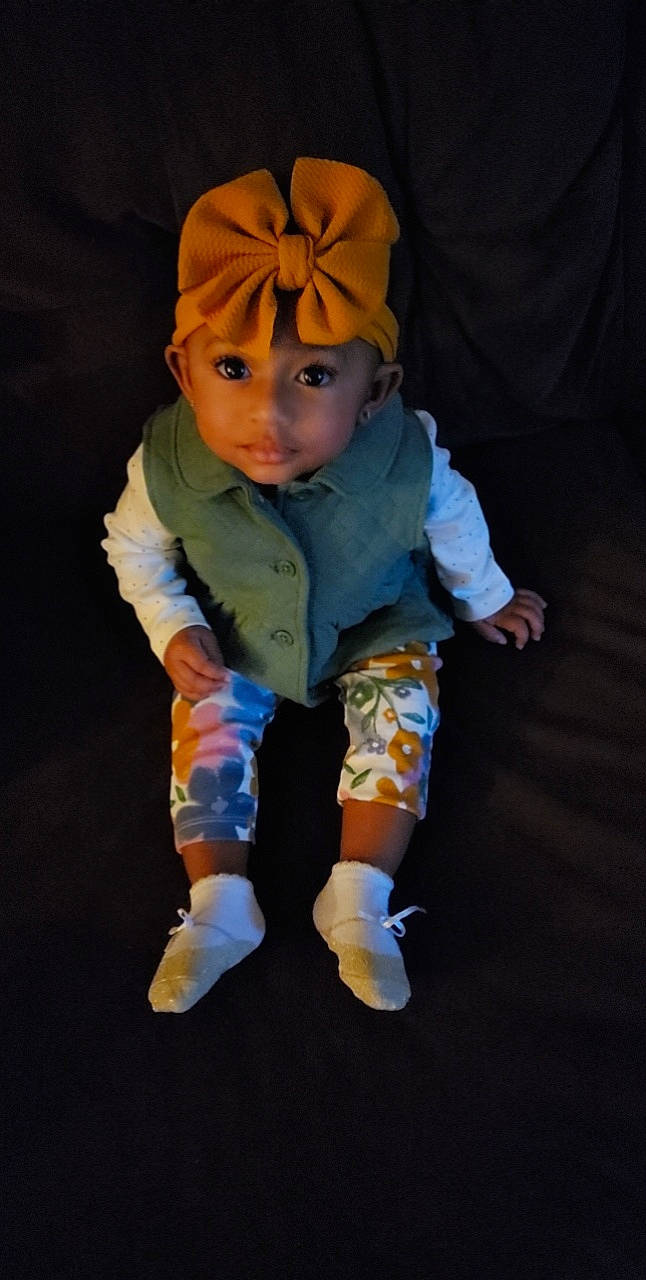 Alaiyah joined the competition — help win amazing prizes! baby, baby_toddler_clothing, beanie, cap, child, comfort, costume, costume_hat, electric_blue, fictional_character, flooring, fun, headwear, pattern, person, personal_protective_equipment, sitting, sleeve, thumb, toddler