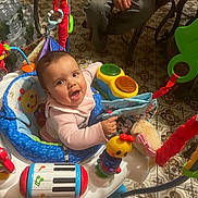 Aurora joined the competition — help win amazing prizes! baby, child, activity_jumper, toy, smile, indoor, floor_tile, adult_hand, colorful, music_toy, playtime, person, seat, pattern, happy, infant, clothing, furniture, expression, cute