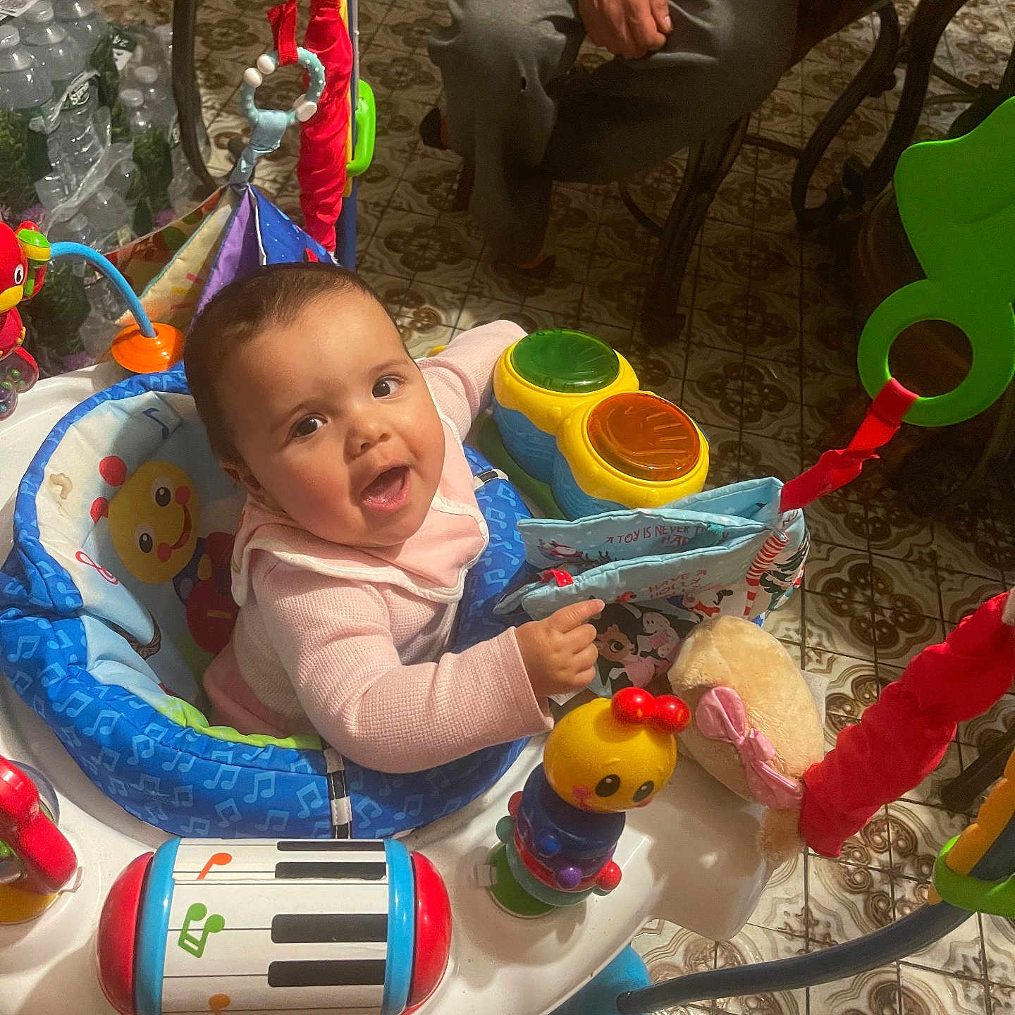 Aurora joined the competition — help win amazing prizes! baby, child, activity_jumper, toy, smile, indoor, floor_tile, adult_hand, colorful, music_toy, playtime, person, seat, pattern, happy, infant, clothing, furniture, expression, cute