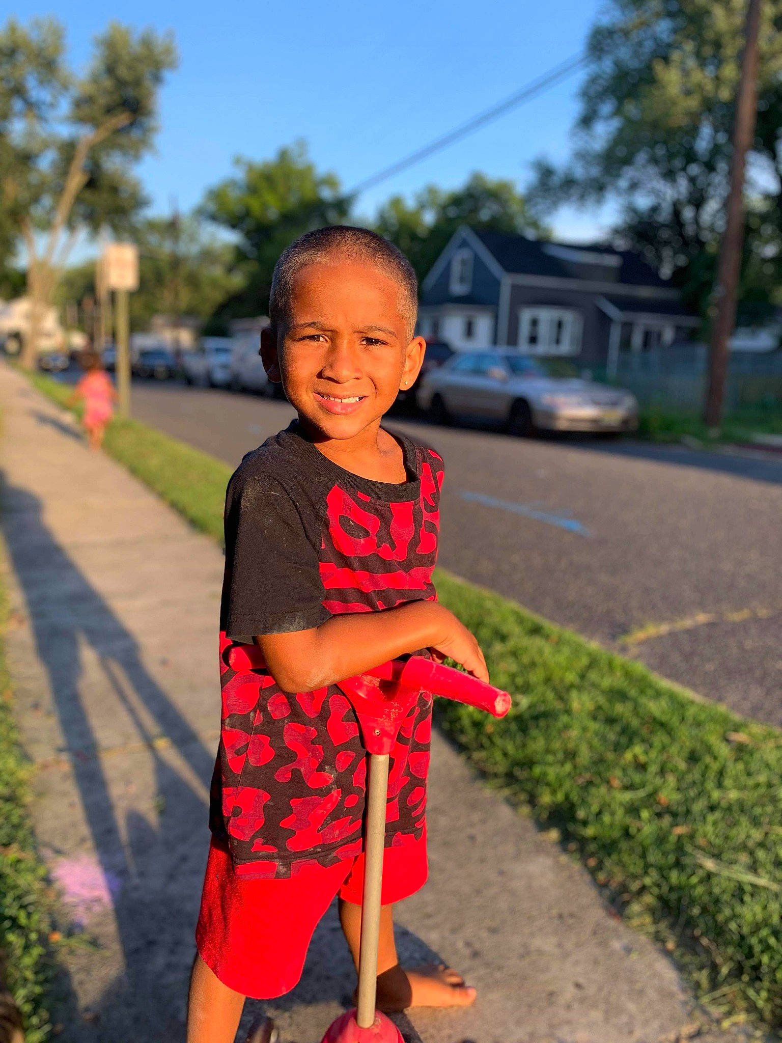 Jeremiah is registered to the contest to win money with this photo: child, design, dress, face, fun, grass, happy, joy, person, photography, plaid, plant, play, red, shoe, skin, smile, snapshot, summer, toddler
