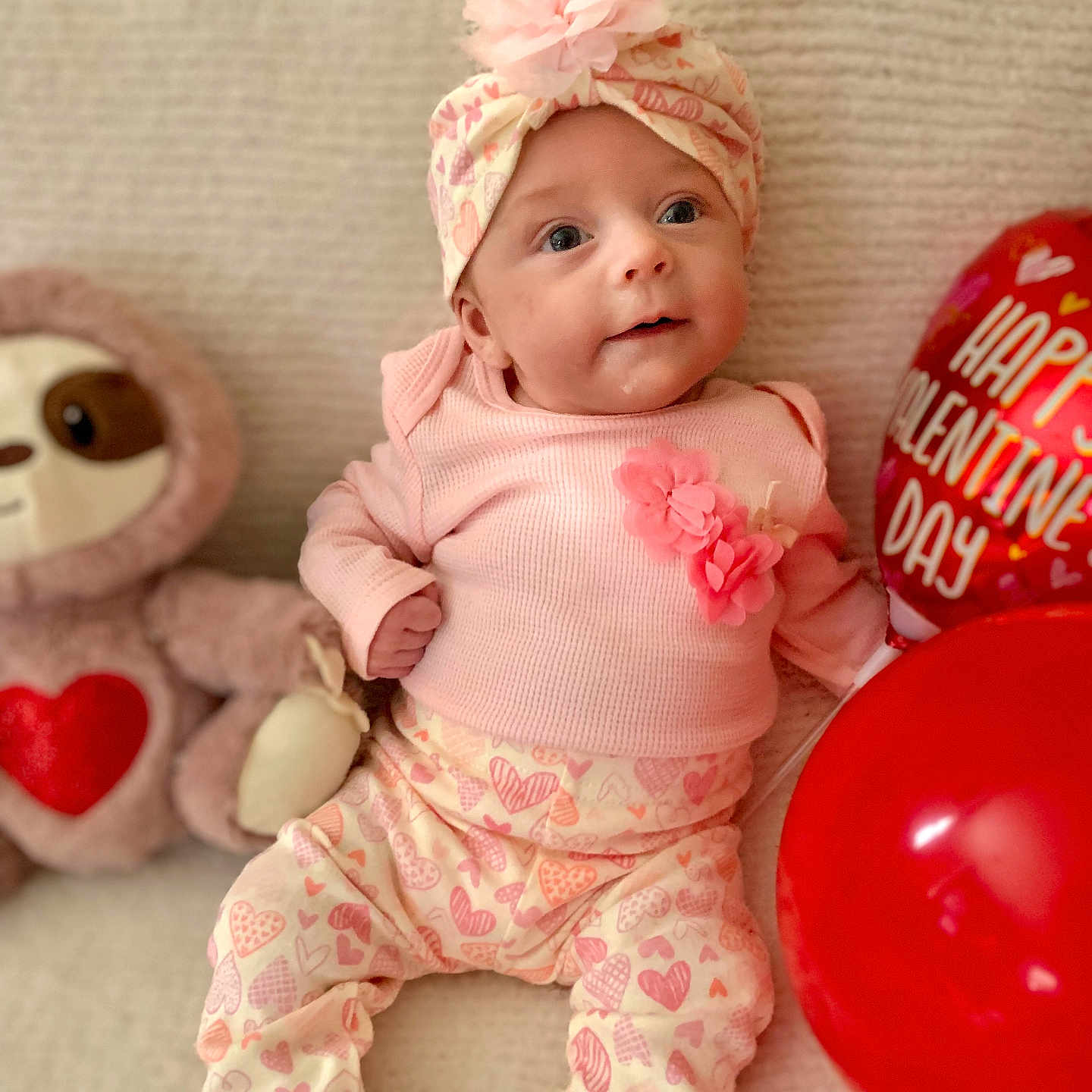 Zeviah joined the competition — help win amazing prizes! baby, balloon, celebration, child, cozy, cute, flower, happy, headband, heart_pattern, holiday, indoor, infant, pink_clothing, plush_toy, portrait, sitting, smiling, soft_texture, valentine