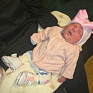 Kacey joined the competition — help win amazing prizes! baby, sleeping, pink_bow, knitted_sweater, white_hat, blanket, white_shoes, patterned_leggings, hand, fabric, wooden_floor, infant, cute, resting, child, indoors, soft, clothing, person, newborn