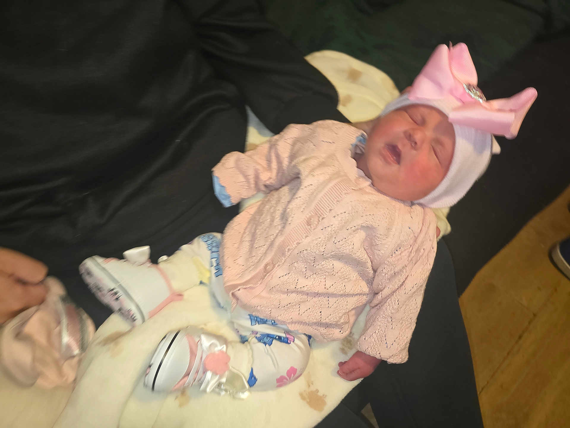 Kacey joined the competition — help win amazing prizes! baby, sleeping, pink_bow, knitted_sweater, white_hat, blanket, white_shoes, patterned_leggings, hand, fabric, wooden_floor, infant, cute, resting, child, indoors, soft, clothing, person, newborn