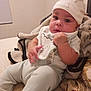 Hezekiah is registered to the contest to win money with this photo: baby, infant, hat, clothing, blanket, bed, pillow, face, hand, sitting, indoors, cute, child, young, soft, cozy, portrait, expression, warm, comfortable
