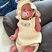 Savannah is registered to the contest to win money with this photo: baby, infant, pacifier, hat, bonnet, clothing, bed, pillow, blanket, fabric, cute, small, resting, indoors, child, newborn, soft, skin, person, portrait