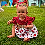 Melina participe au concours pour gagner de l'argent avec cette photo : baby, child, grass, outdoor, dress, red_top, floral_pattern, belt, ponytails, barefoot, greenery, summer, sitting, lawn_chair, blurred_background, cute, serious_expression, nature, playtime, portrait