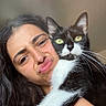 Prune participe au concours pour gagner de l'argent avec cette photo : woman, cat, black_and_white_cat, face, portrait, indoor, funny_face, pet, holding, long_hair, expression, close_up, looking_at_camera, whiskers, domestic_cat, human, cute, animal, feline, affection