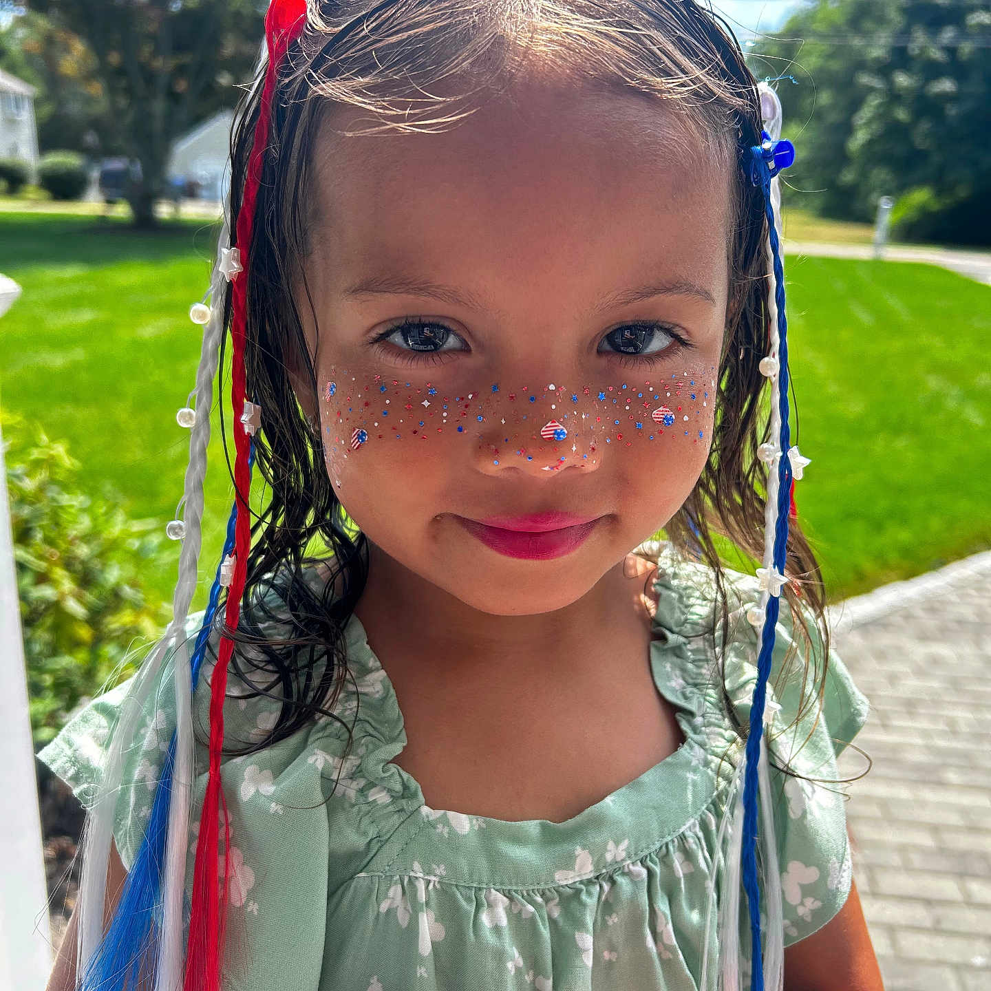 Aria Rose is registered to the contest to win money with this photo: child, girl, face, portrait, outdoor, sunlight, greenery, dress, braids, ribbons, glitter, patriotic, stars, beads, smile, young, cute, nature, happy, summer