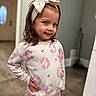 child, girl, pajamas, unicorn, headband, bow, smile, pose, indoors, floor, wall, door, hand_on_hip, long_hair, cute, happy, person, clothing, portrait, home