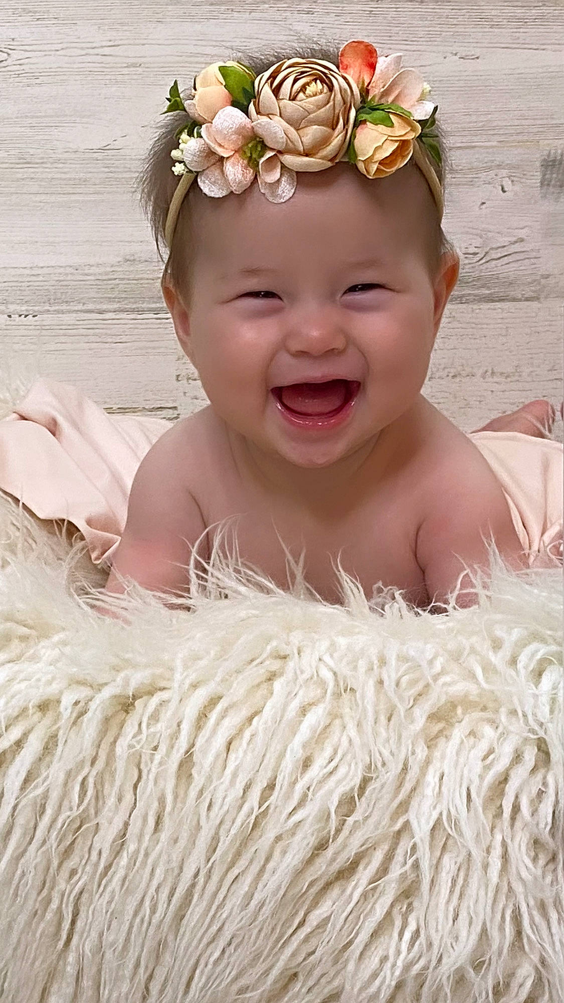 Mia is registered to the contest to win money with this photo: baby, baby_toddler_clothing, child, crown, event, face, fashion_accessory, flower, hair_accessory, happy, headband, headpiece, headwear, jewellery, lei, peach, people_in_nature, person, plant, smile