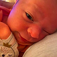 Journey is registered to the contest to win money with this photo: baby, newborn, close_up, face, mitten, clothing, sleepy, skin, hand, portrait, resting, soft, cute, infant, young, warm, comfort, expression, person, indoors