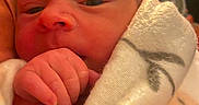 Journey is registered to the contest to win money with this photo: baby, blanket, close_up, cozy, cute, face, hand, human, indoors, infant, newborn, newborn_baby, person, portrait, skin, sleepy, soft, tender, warm, wrapped