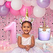 Bella joined the competition — help win amazing prizes! child, toddler, birthday, unicorn, balloons, cake, pink, purple, white, dress, smile, party, celebration, headband, number_one, decorations, happy, posing, background, festive