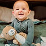 Beckett joined the competition — help win amazing prizes! baby, child, teddy_bear, plush_toy, smile, happy, bed, blanket, cozy, indoors, cute, person, infant, clothing, soft_toy, corduroy, sitting, portrait, warm, comfort