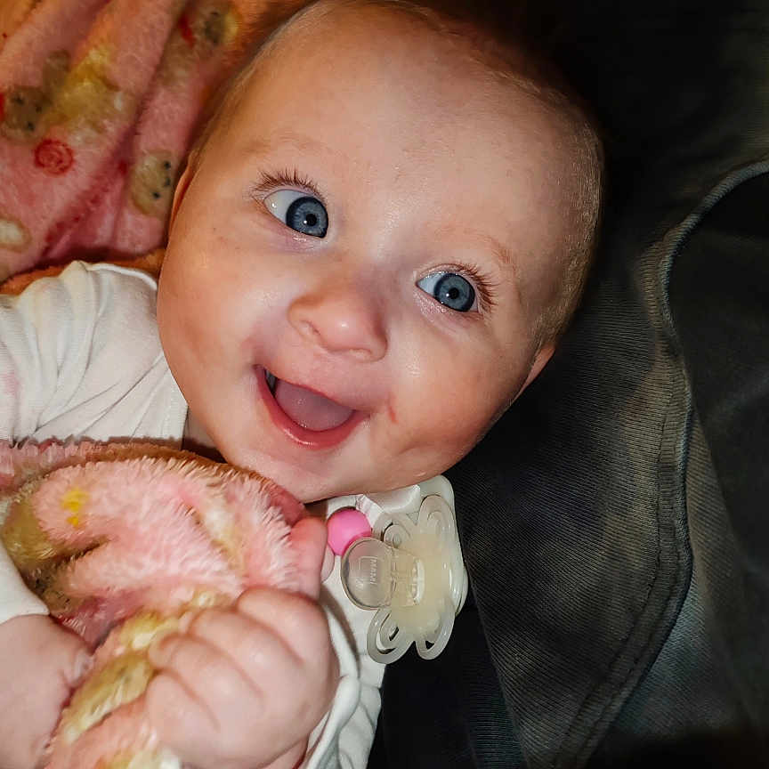 Elaina Lila is registered to the contest to win money with this photo: baby, babylaughing, blanket, bodypart, bonnet, clothing, face, finger, hand, happy, hat, head, laughing, mouth, newborn, person, photography, portrait, smile, teeth