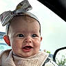Margaret joined the competition — help win amazing prizes! baby, infant, child, smiling, happy, portrait, face, bow, headband, bib, car, car_seat, vehicle, indoors, passenger, close_up, eyes, mouth, photography, family