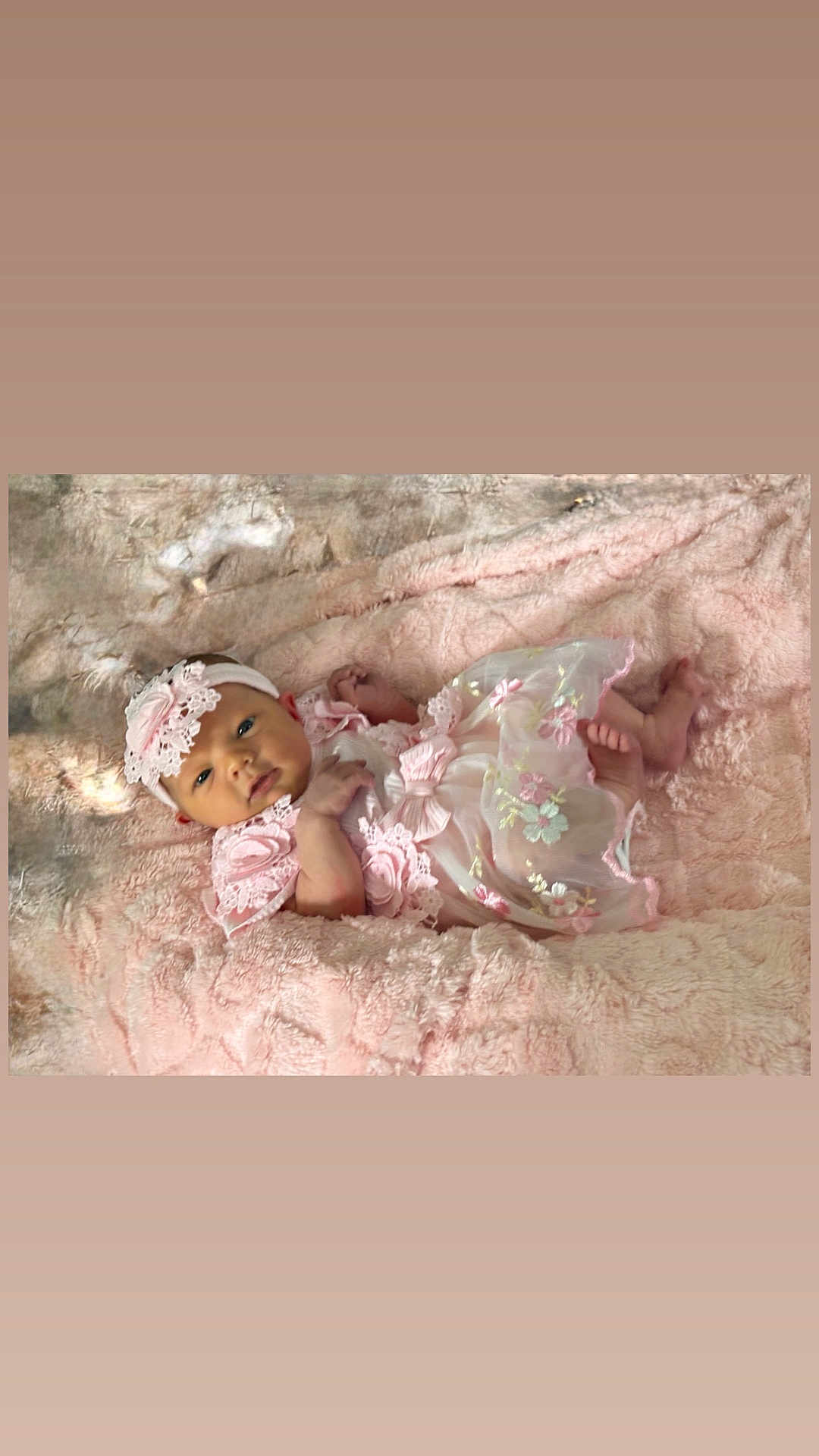 Aria is registered to the contest to win money with this photo: baby, infant, pink_dress, headband, blanket, soft_texture, cute, portrait, lying_down, child, young_baby, indoor, fabric, lace, flower_pattern, foot, hand, face, smile, adorable
