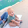 Isaiah joined the competition — help win amazing prizes! baby, child, smile, green_onesie, mat, outdoor, concrete_floor, mural, sea_creatures, person, jeans, sneakers, happy, playful, cute, infant, sitting, casual, colorful, daylight