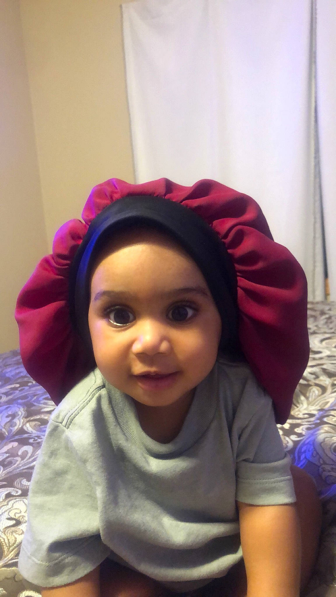 Avaya is registered to the contest to win money with this photo: cap, cheek, chin, cool, eyebrow, eyelash, face, forehead, hairstyle, happy, head, headgear, headwear, human_body, lip, mouth, nose, outerwear, person, purple