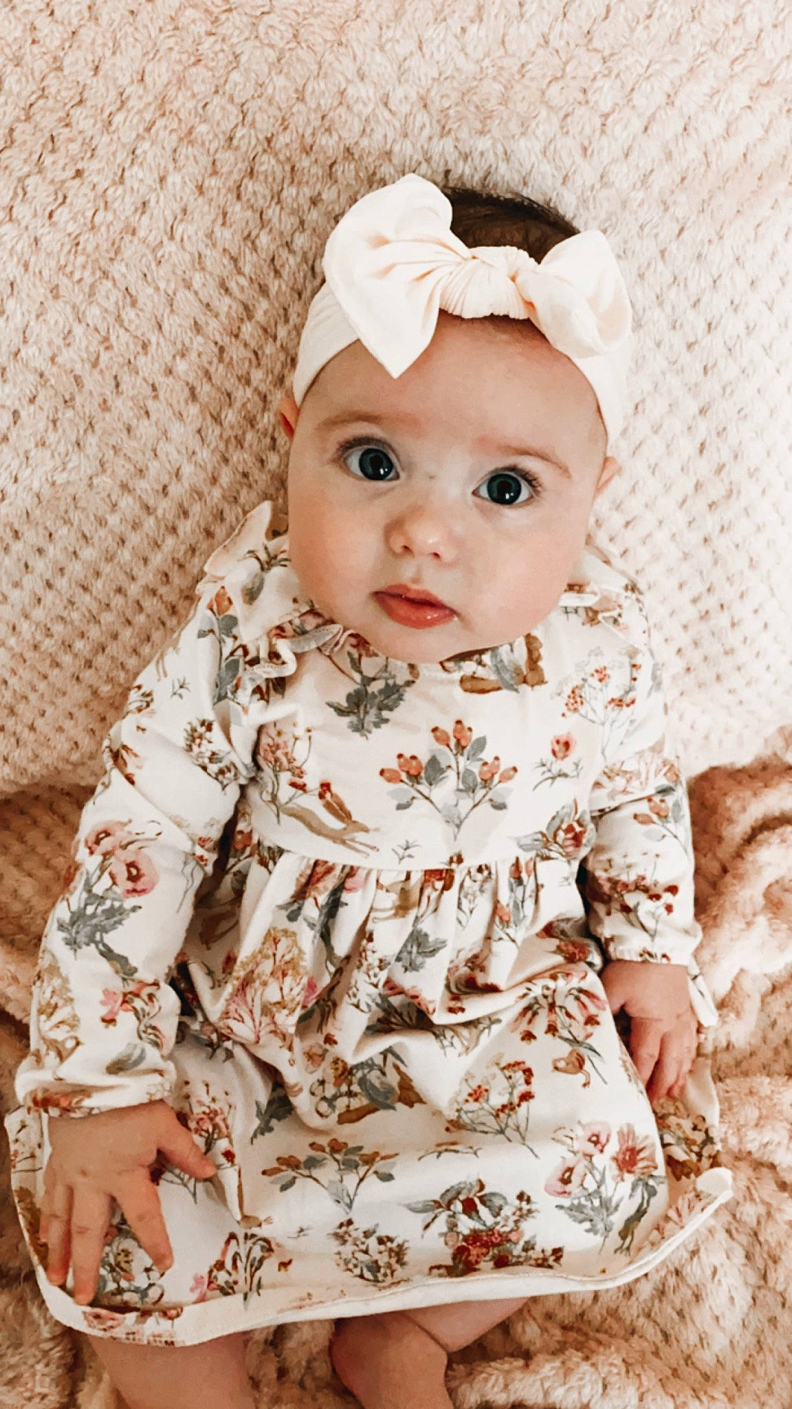 Phoebe is registered to the contest to win money with this photo: baby, baby_toddler_clothing, beige, cheek, child, clothing, dress, fashion_accessory, hair_accessory, head, headband, headgear, headwear, pattern, peach, person, pink, sleeve, toddler