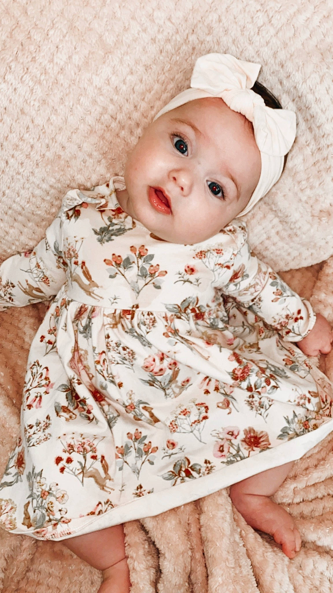 Phoebe is registered to the contest to win money with this photo: baby, baby_products, baby_toddler_clothing, child, child_model, clothing, dress, headgear, headwear, pattern, peach, person, sleeve, toddler