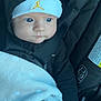 baby, infant, car_seat, blanket, hood, hat, jumpman_logo, buckle, seatbelt, blue_eyes, hand, fingers, black_clothing, closeup, portrait, newborn, cozy, soft_texture, cute, pacifier
