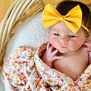 Trinity is registered to the contest to win money with this photo: baby, newborn, bow, headband, wicker_basket, blanket, swaddle, floral_pattern, infant, portrait, cute, rosy_cheeks, hand, face, eyes, skin, cozy, soft_texture, wood_floor, closeup
