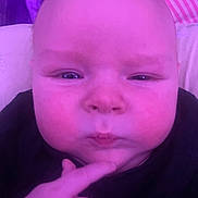 Aiden is registered to the contest to win money with this photo: baby, child, chubby_cheeks, close_up, cute, expression, face, finger, hand, head, indoor, infant, person, pink_light, portrait, purple_light, skin, soft_light, thinking, young