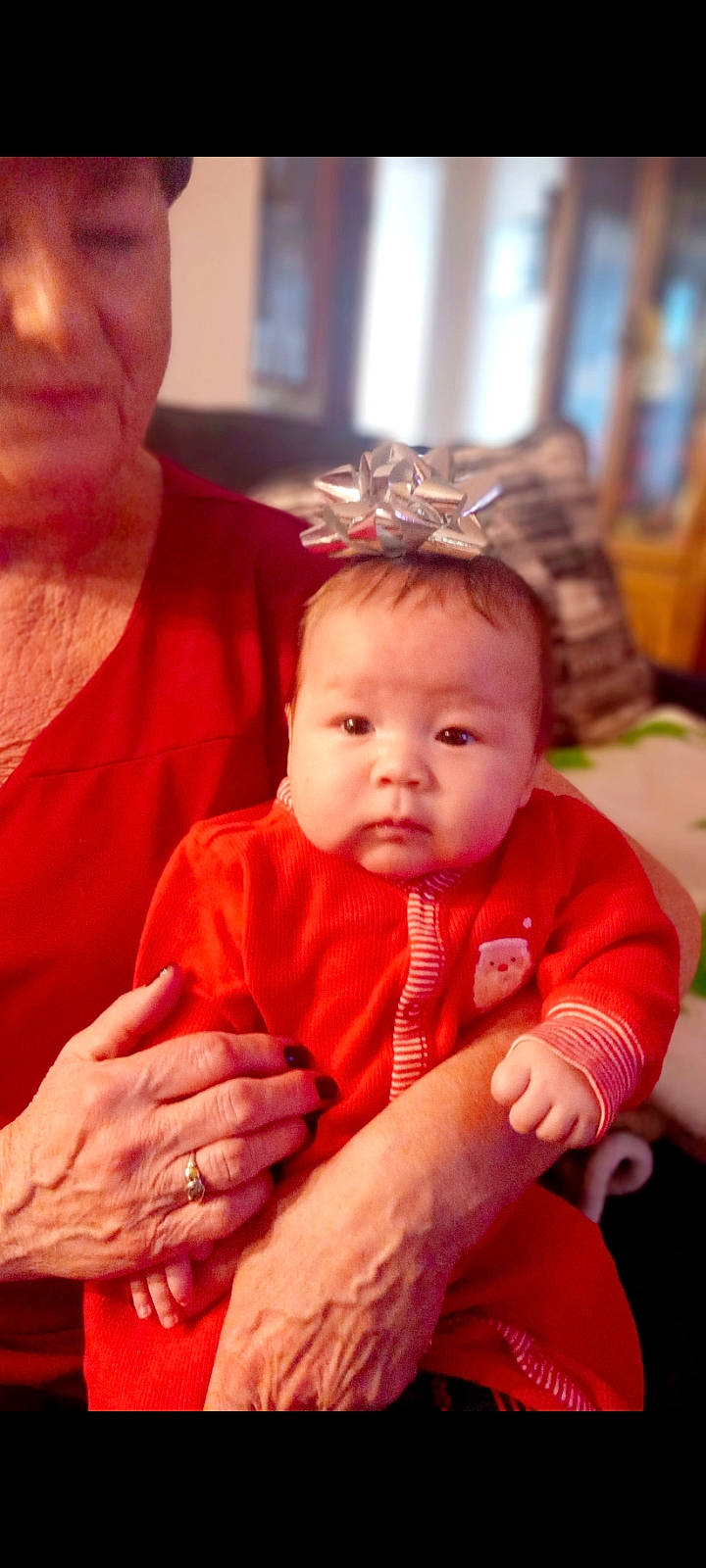 Maya is registered to the contest to win money with this photo: arm, baby, baby_toddler_clothing, cheek, child, ear, event, facial_expression, finger, fun, gesture, hairstyle, happy, iris, jewellery, lip, person, sitting, skin, thumb