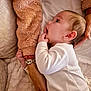 Chloé participe au concours pour gagner de l'argent avec cette photo : baby, infant, child, hand, face, blanket, fabric, pajamas, sleepwear, adult_hand, bracelet, skin, comfort, cozy, texture, lying_down, looking_up, curious, closeup, indoor