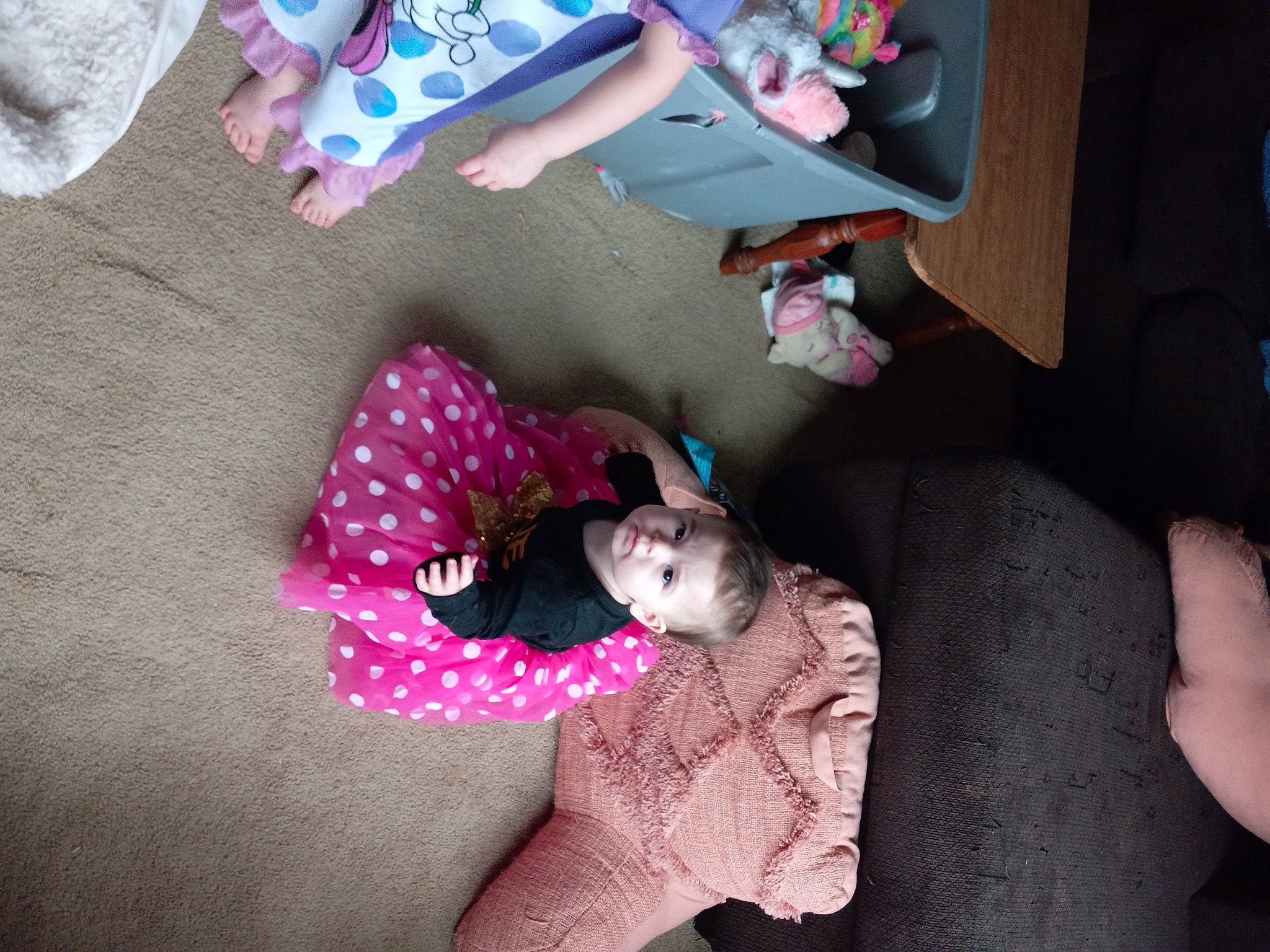 Tiffanie is registered to the contest to win money with this photo: beauty, child, comfort, finger, flooring, fun, human_leg, lap, linens, magenta, mammal, pattern, person, pink, play, purple, room, sitting, textile, thigh