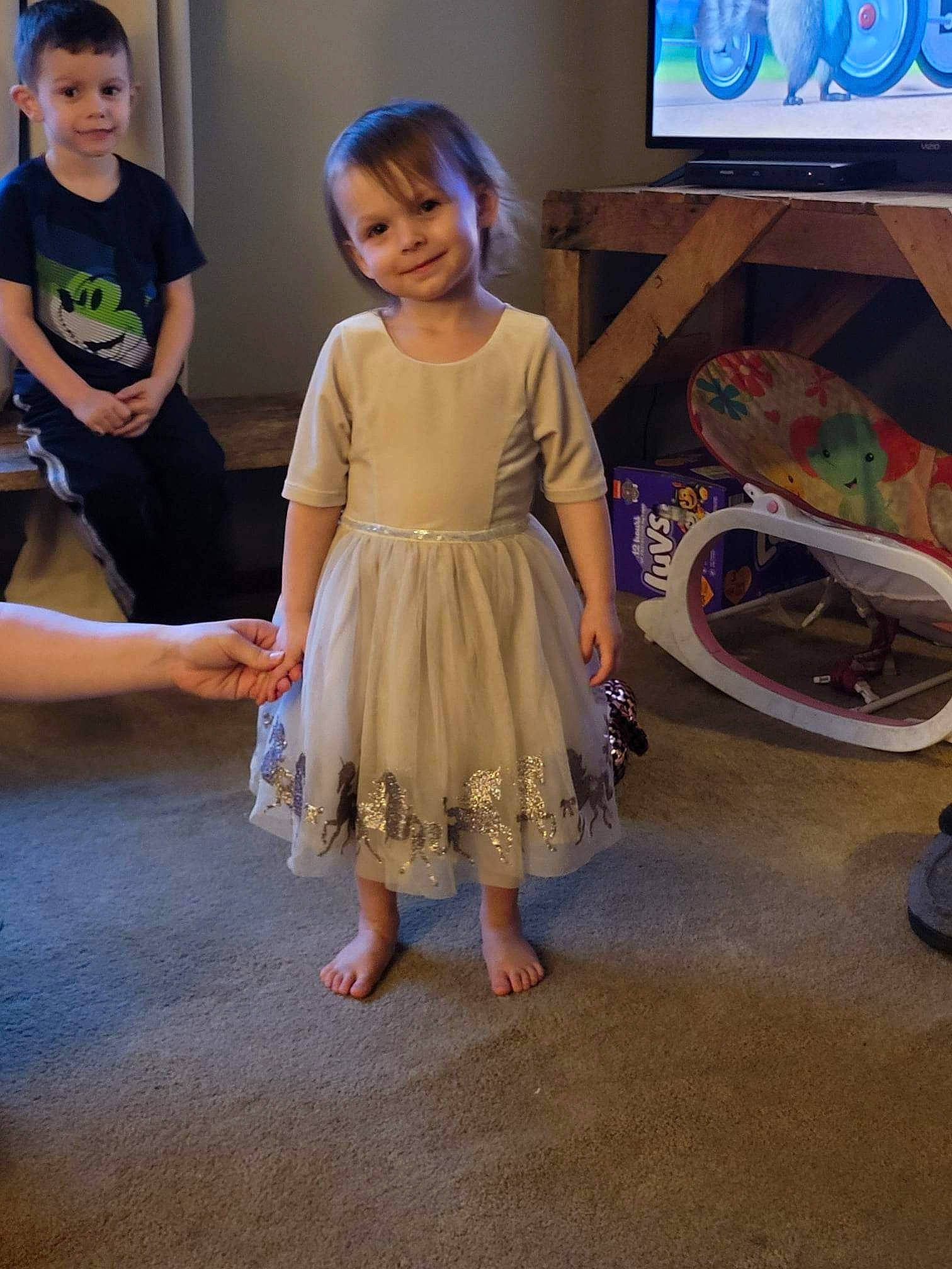 Autumn is registered to the contest to win money with this photo: barefoot, child, day_dress, dress, event, fashion_design, flooring, foot, fun, happy, human_leg, joy, leisure, one_piece_garment, person, room, shoulder, smile, t_shirt, television