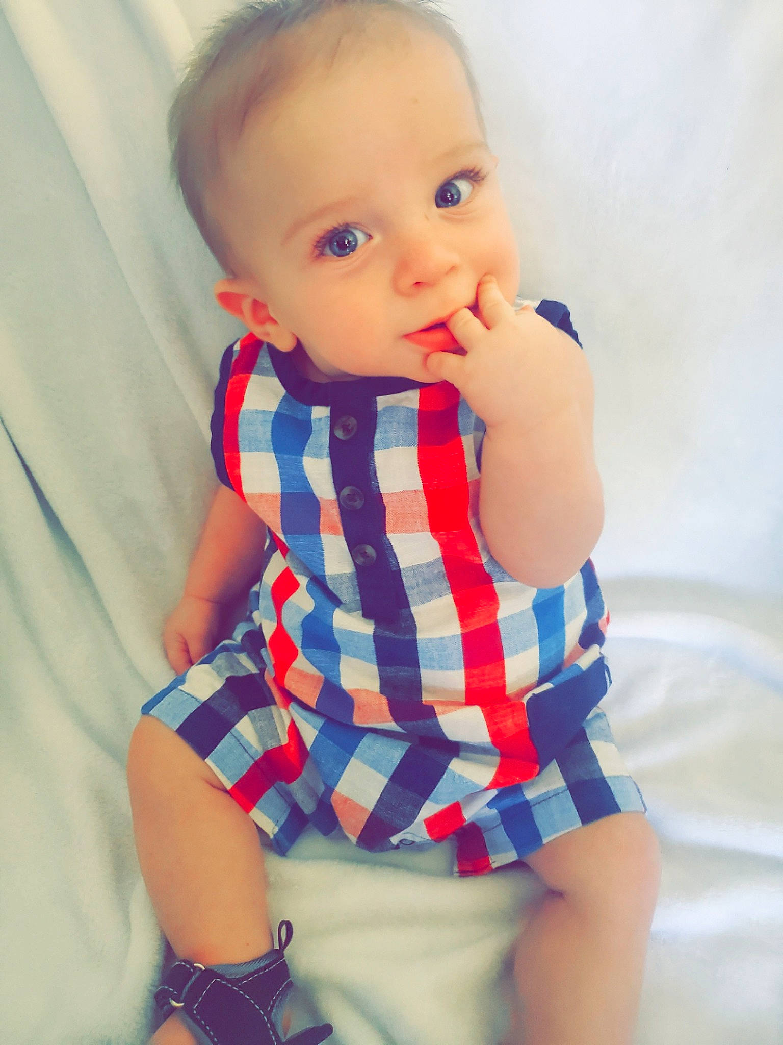 Cain is registered to the contest to win money with this photo: aqua, azure, baby, baby_toddler_clothing, elbow, eye, face, gesture, head, human_body, joint, neck, person, plaid, skin, sleeve, tartan, thigh, toddler, waist