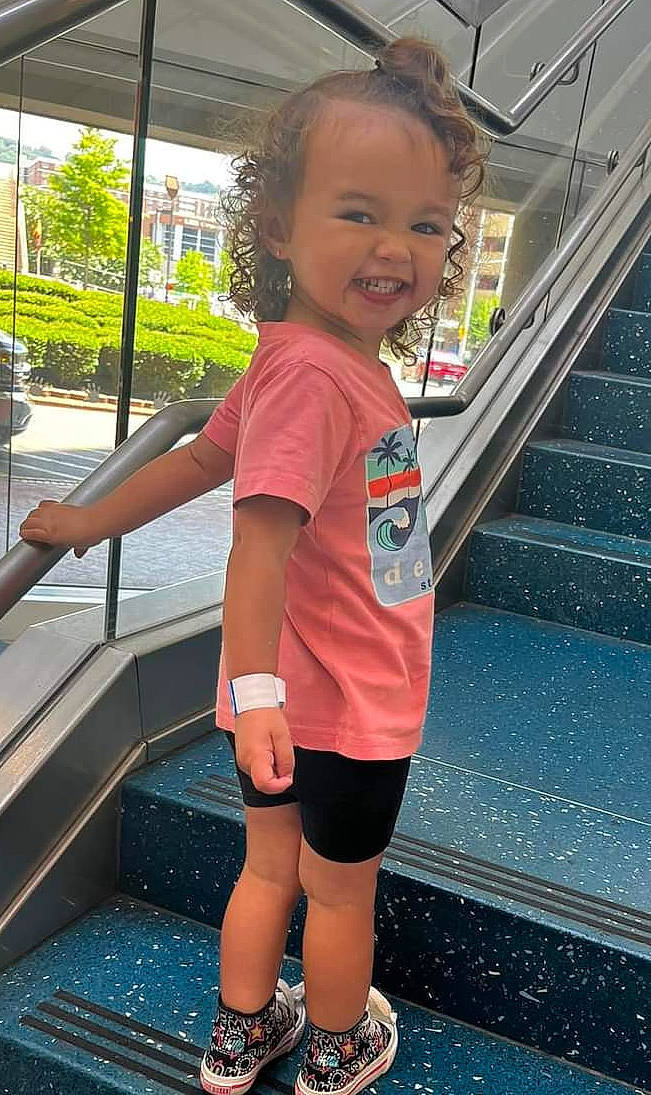 Alena is registered to the contest to win money with this photo: child, electric_blue, fun, hairstyle, happy, human_leg, leisure, person, pink, recreation, shorts, smile, snapshot, stairs, t_shirt, thigh, toddler, travel, tree, waist