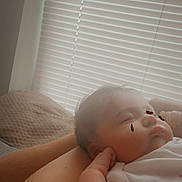 Sofia Donahue is registered to the contest to win money with this photo: baby, infant, sleeping, face, portrait, caregiver, arms, indoor, window, blinds, blanket, white_clothing, cozy, peaceful, relaxed, close_up, home, soft_lighting, child, resting