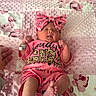 newborn, baby, infant, child, portrait, lying_down, pink, bow, headband, onesie, clothing, blanket, floral, bed, sleeping, yawning, hands, feet, hospital_bracelet, family_photo