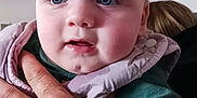 Youenn participe au concours pour gagner de l'argent avec cette photo : baby, child, hand, face, blue_eyes, clothing, pink_bib, green_shirt, portrait, indoor, person, skin, young_child, holding, closeup, expression, human, head, cheeks, background_photos
