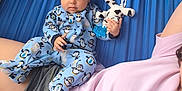 Udaya joined the competition — help win amazing prizes! adult, baby, blue, casual, child, clothing, cow_toy, cute, fabric, hammock, infant, laying_down, onesie, outdoor, penguin_pattern, person, plush_toy, portrait, relaxing, resting