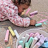 Udaya is registered to the contest to win money with this photo: art, chalk, chalk_bucket, child, concentration, creative, curly_hair, drawing, girl, outdoor, pastel_colors, pavement, pink_jacket, play, ponytail, portrait, profile, sidewalk, sitting, toddler
