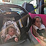 Leomi is registered to the contest to win money with this photo: baby, buckled, car, car_seat, child, curly_hair, daylight, face, family, infant, infant_carrier, outdoor, portrait, road_trip, safety_harness, siblings, sitting, steering_wheel, toddler, vehicle_interior