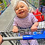 baby, child, shopping_cart, headband, smile, happy, clothing, store, aisle, hand, curly_hair, infant, purple_outfit, person, retail, toddler, indoor, cute, holding, face